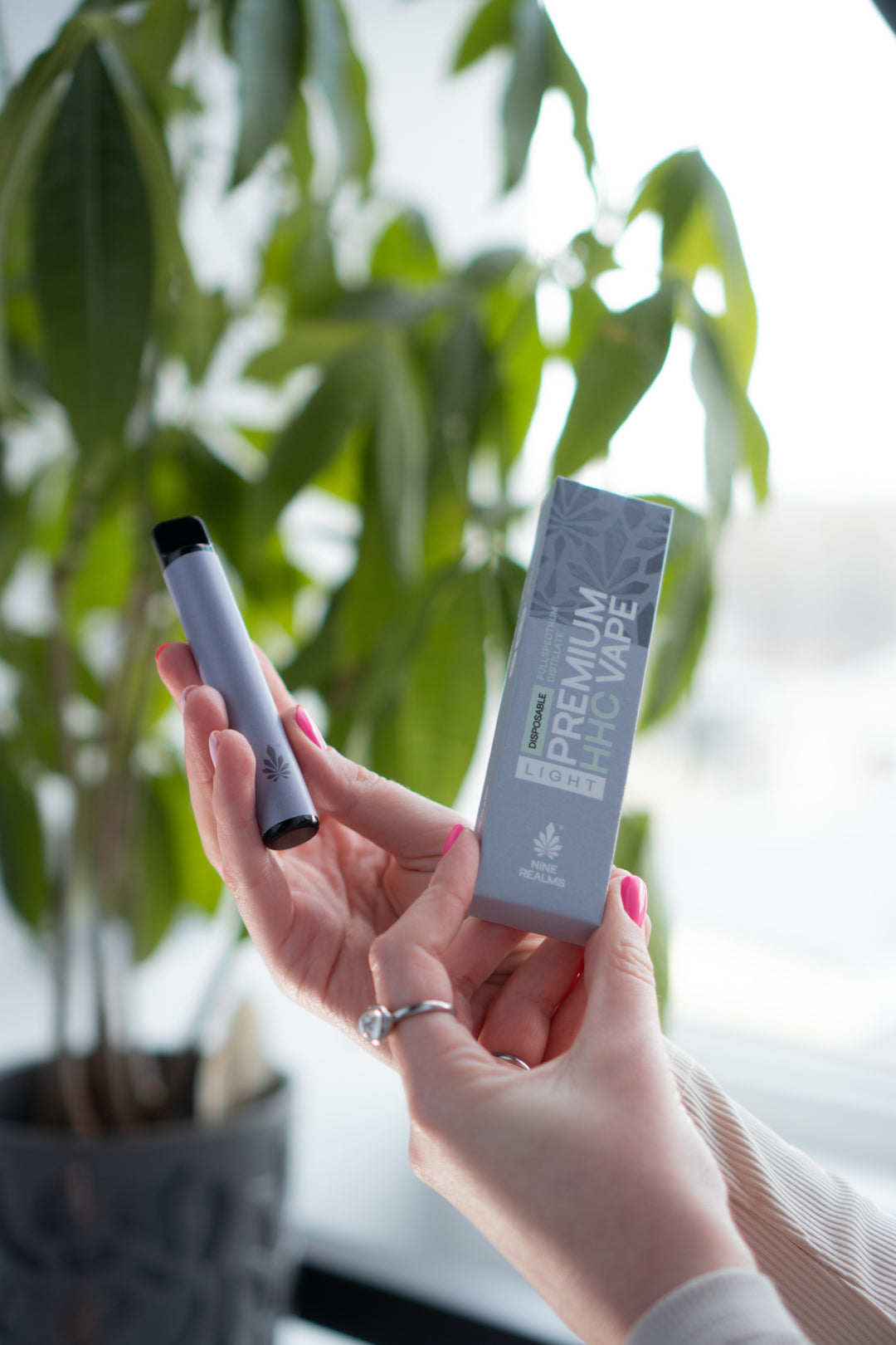 a model holding a premium vape and packaging in an office environment