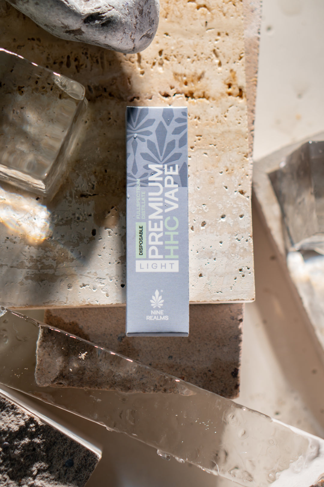 nine realms premium hhc vape packaging in a natural artistic composition