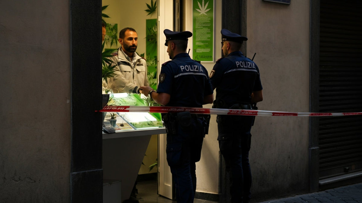 Italian police standing next to a Nine Realms CBD store