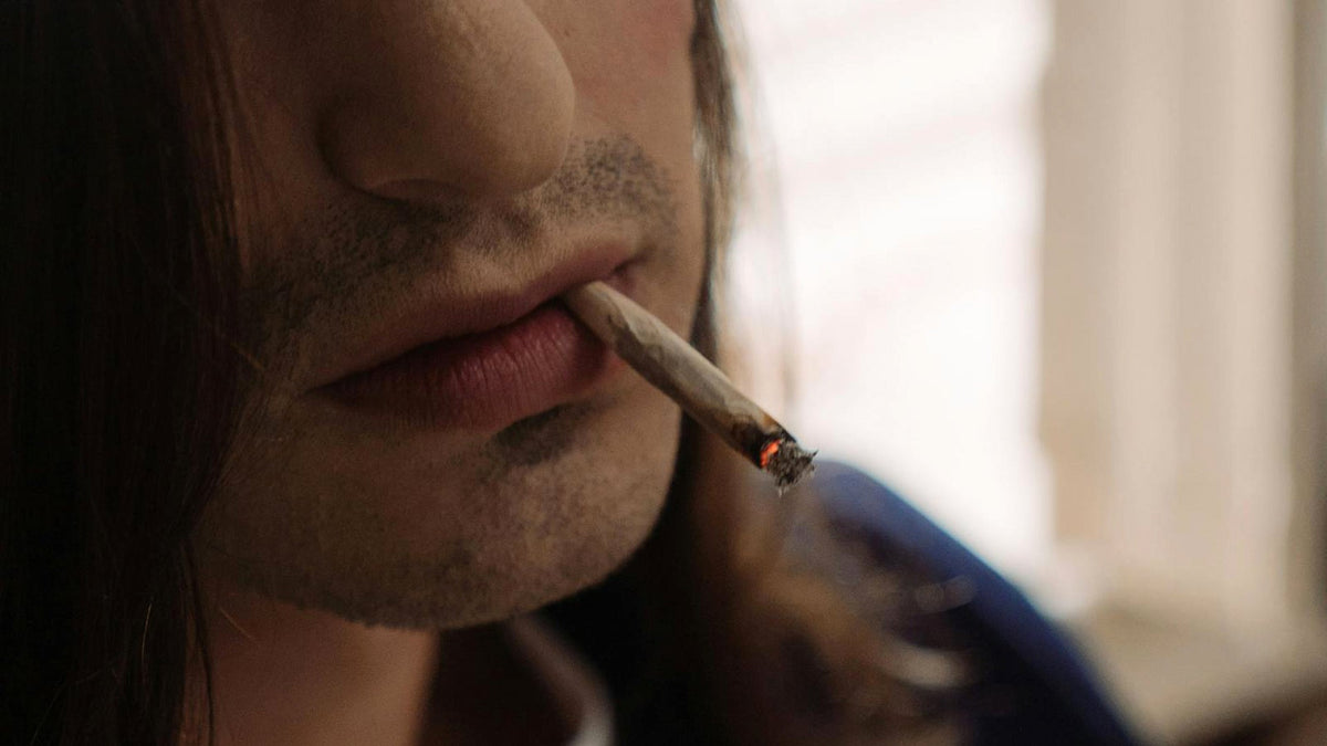 Nine Realms Customer Smoking a Cannabis Joint