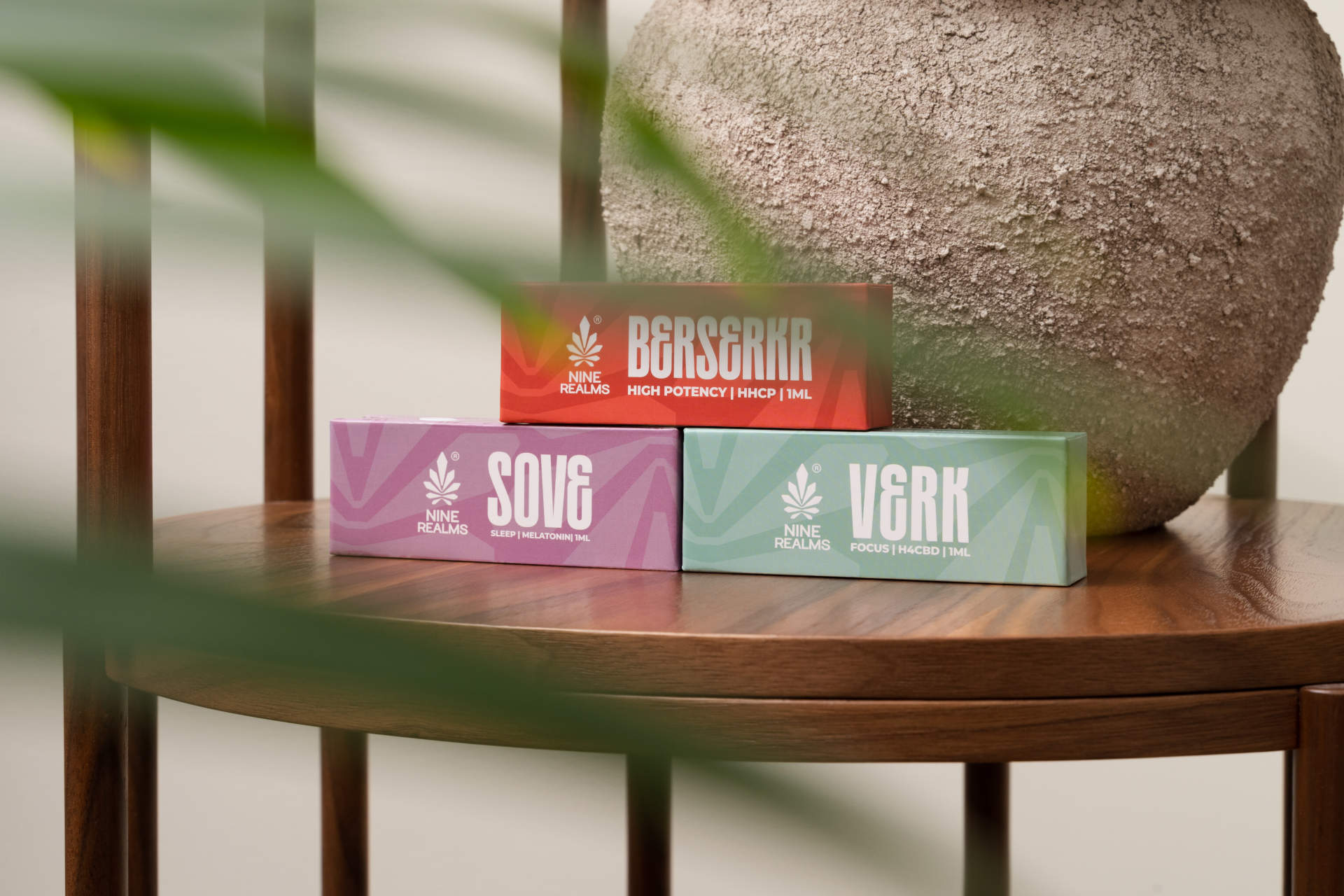 Three different Nine Realms Cartridges on a wooden table