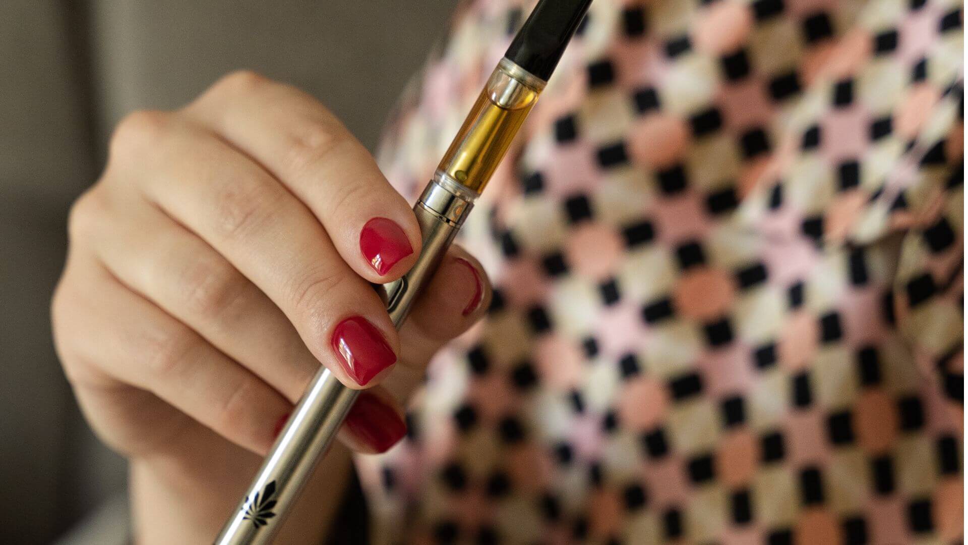 Female holding Nine Realms CBD Cartridge available for purchase