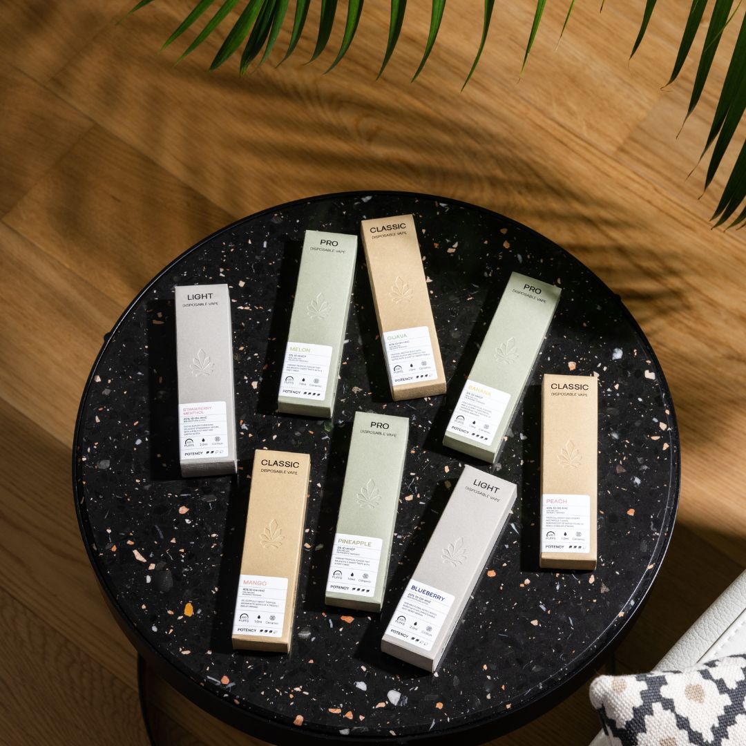 a bunch on Nine Realms THC Vapes on a black table