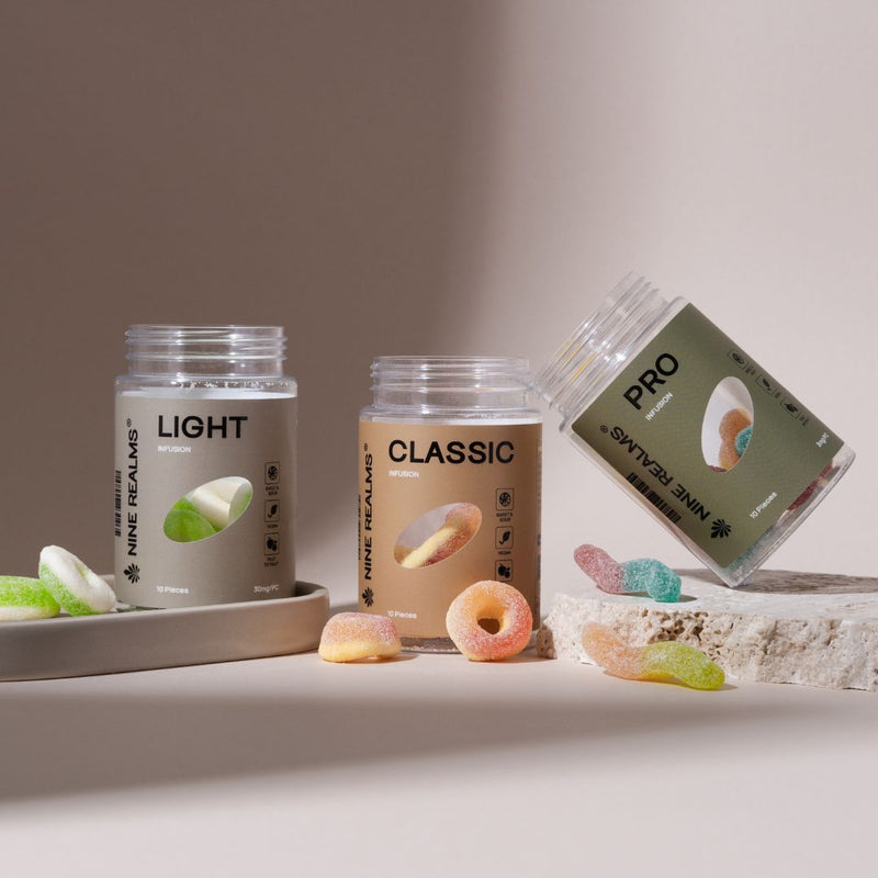 Three clear jars of Nine Realms gummies on a beige background