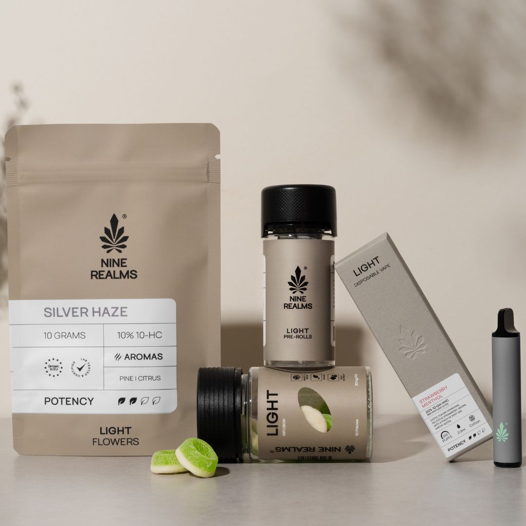 Nine realms LIGHT bundle with gummies, flower, pre-rolls and a disposable vape on a grey table