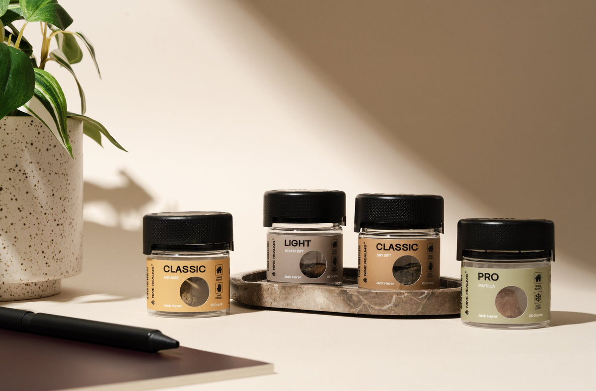 Nine Realms LIGHT, CLASSIC and PRO hash jars lined up on a light desk